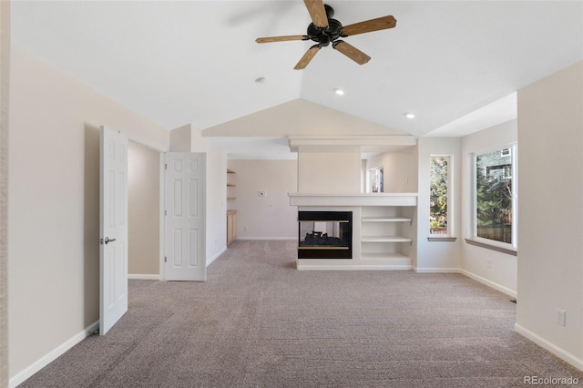 unfurnished living room with lofted ceiling, carpet, a multi sided fireplace, and baseboards