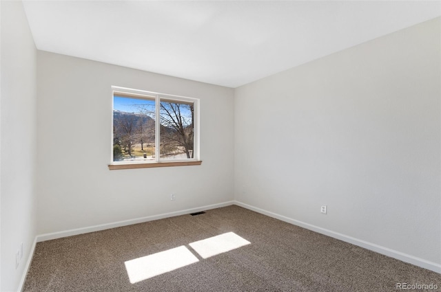 unfurnished room featuring visible vents, baseboards, and carpet flooring