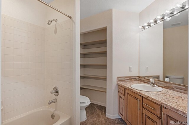 bathroom featuring visible vents, shower / bathing tub combination, vanity, and toilet