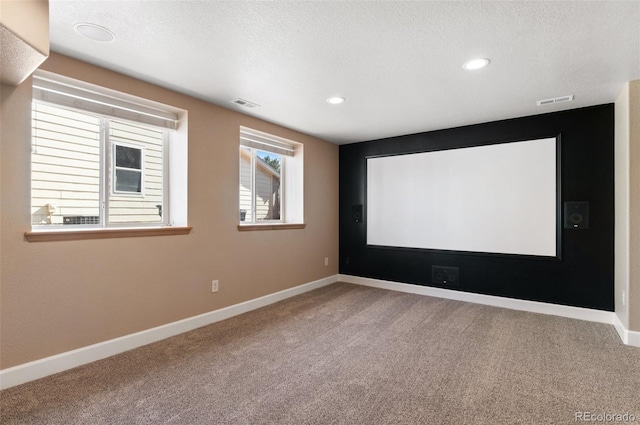 carpeted home theater room with baseboards, visible vents, a textured ceiling, and recessed lighting