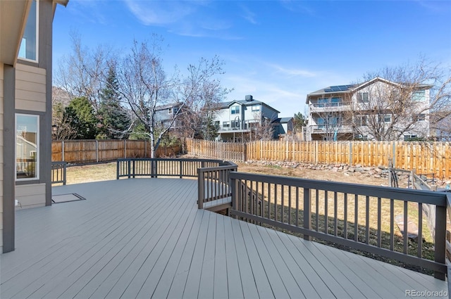 wooden deck featuring a fenced backyard