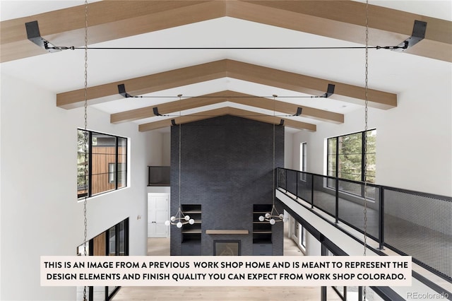 interior space featuring wood-type flooring and vaulted ceiling with beams