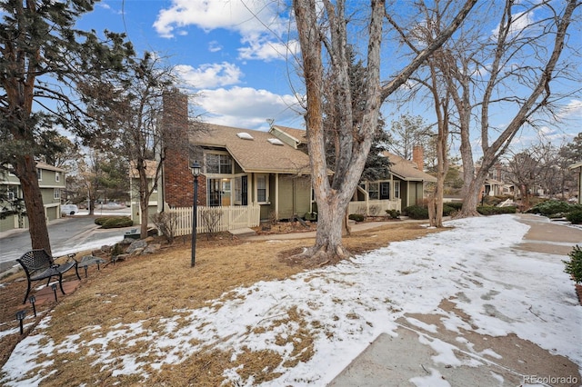 view of front of home featuring fence and a chimney