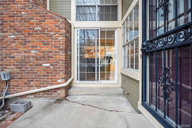 entrance to property with brick siding