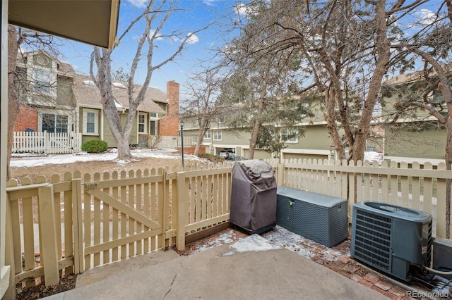 view of patio / terrace with grilling area, a fenced backyard, a gate, and central air condition unit