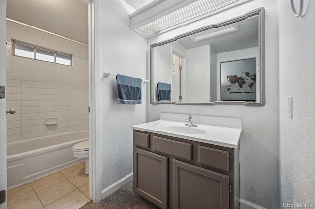 bathroom featuring toilet, vanity, baseboards, shower / bathing tub combination, and tile patterned floors