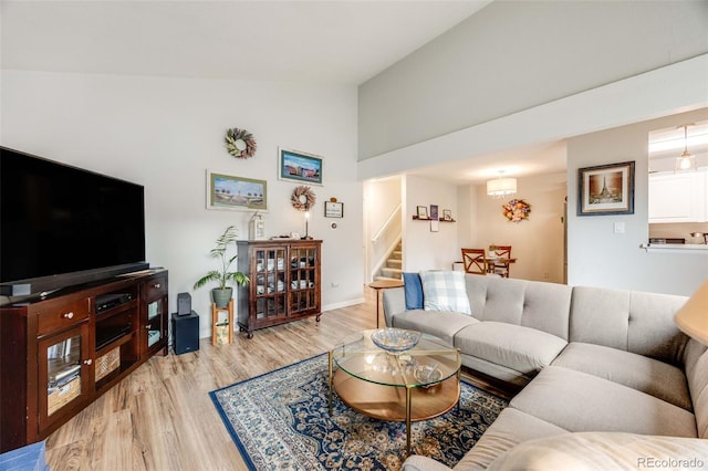 1236 Sequerra St, Broomfield, CO 80020 - living area featuring light wood finished floors, stairs, and high vaulted ceiling