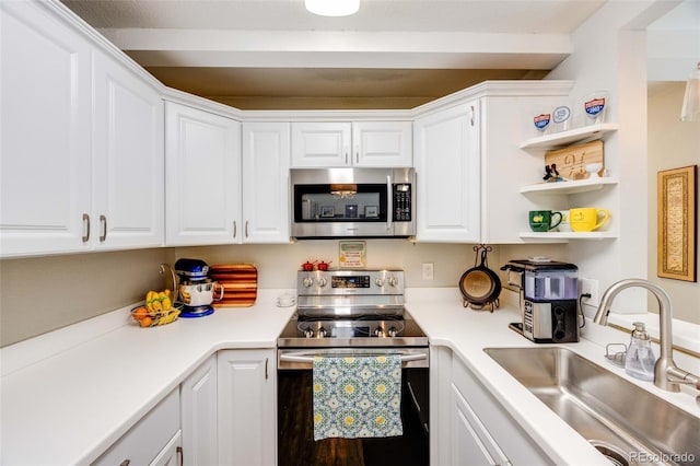 1236 Sequerra St, Broomfield, CO 80020 - kitchen with appliances with stainless steel finishes, white cabinetry, light countertops, and open shelves