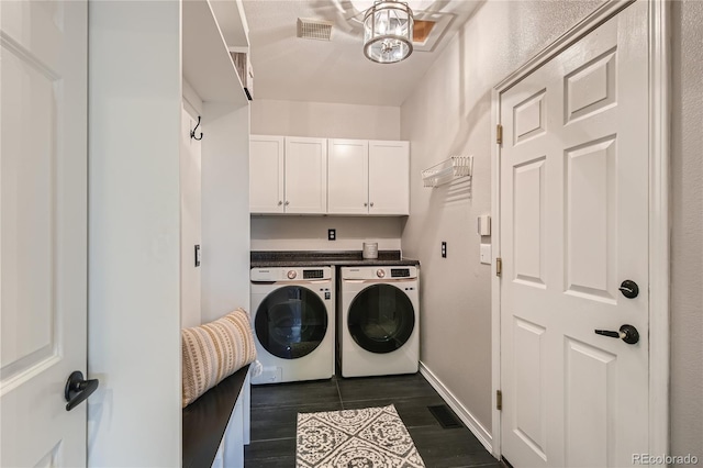 laundry room with cabinets and washing machine and dryer