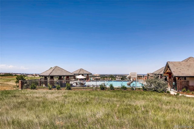 view of yard featuring a gazebo and a fenced in pool