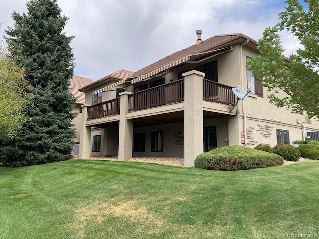 rear view of property featuring a yard