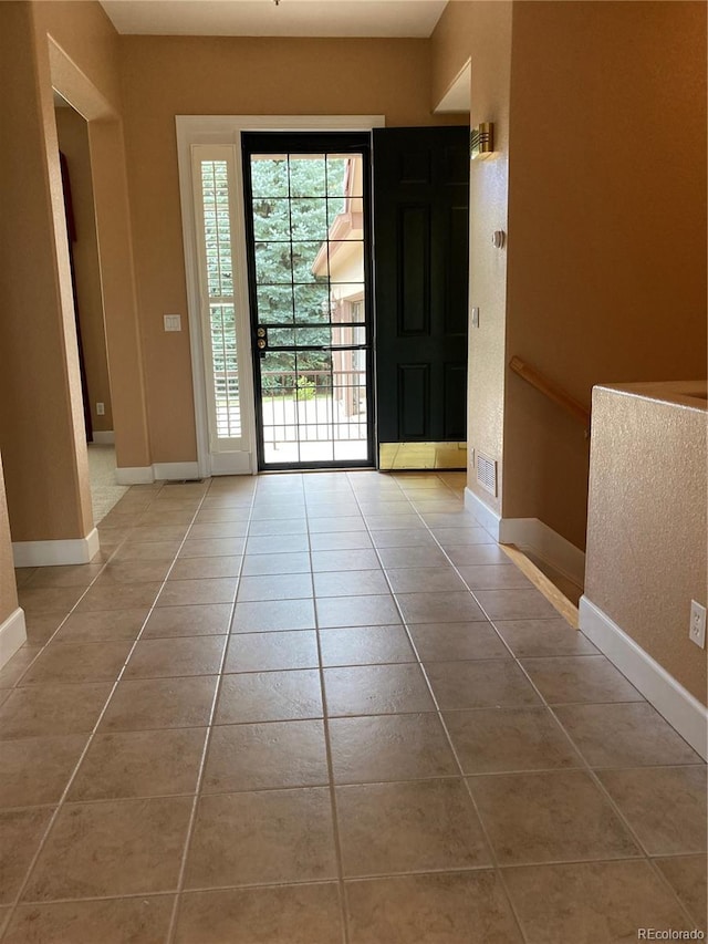 doorway featuring light tile patterned floors