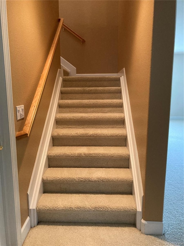 stairs featuring carpet