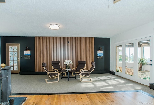 7684 Beverly Blvd, Castle Pines, CO 80108 - dining room featuring a textured ceiling, an accent wall, and hardwood / wood-style flooring