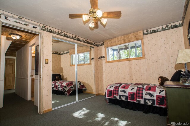 7684 Beverly Blvd, Castle Pines, CO 80108 - bedroom featuring wallpapered walls, carpet floors, a closet, a ceiling fan, and baseboards