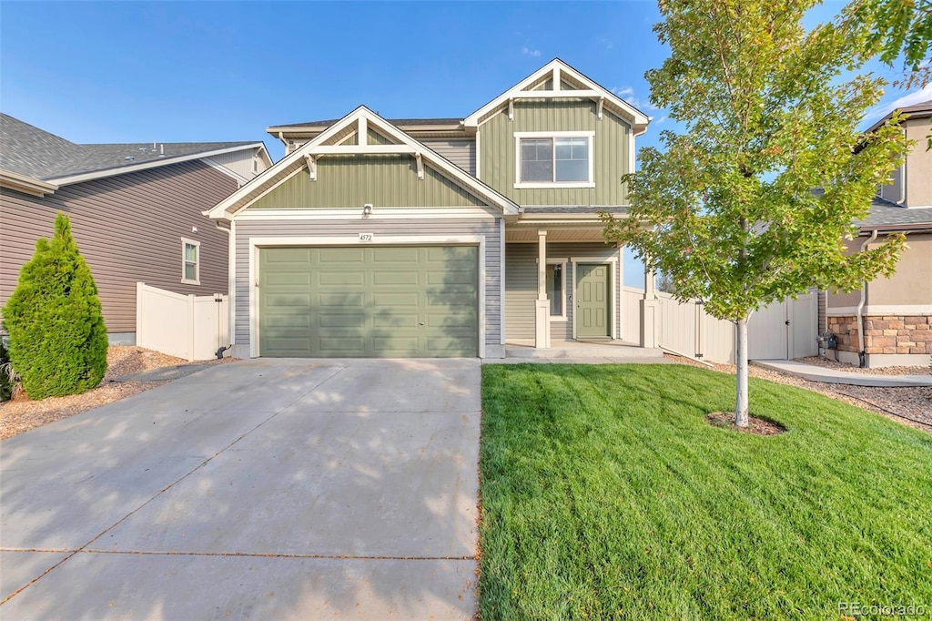 4572 Walden Way, Denver, CO 80249 - craftsman-style home with driveway, board and batten siding, fence, a front yard, and a garage