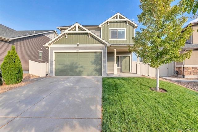 craftsman-style home with driveway, board and batten siding, fence, a front yard, and a garage