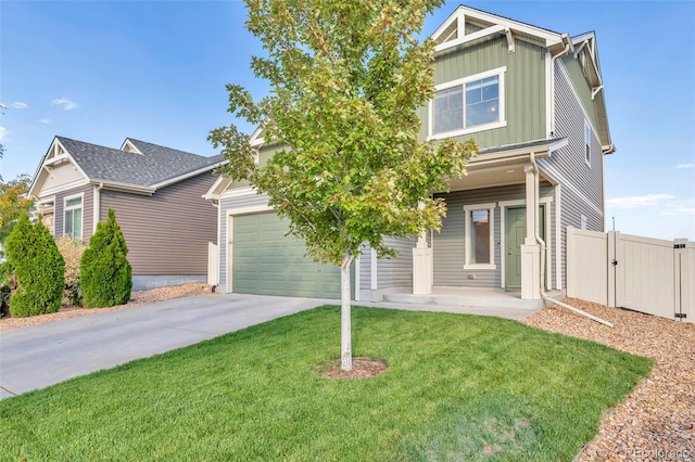 view of front of house with a gate, fence, concrete driveway, board and batten siding, and a front yard