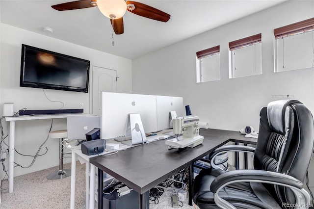 office featuring speckled floor and a ceiling fan