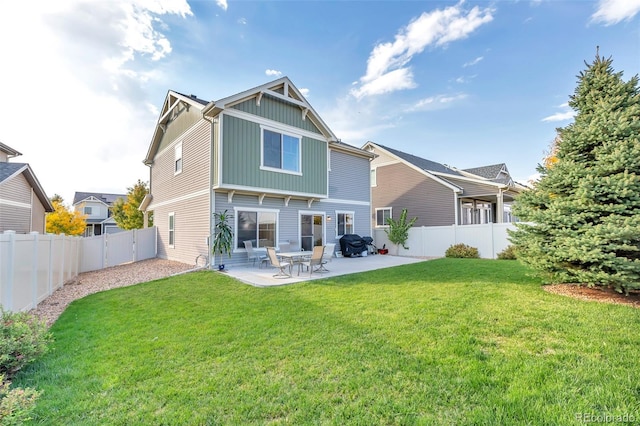 back of property featuring a lawn, a patio area, board and batten siding, and a fenced backyard