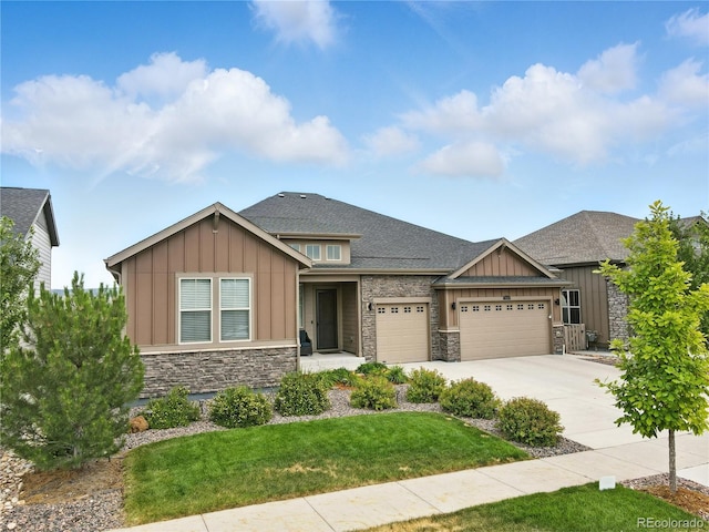 9538 Bear River St, Littleton, CO 80125 - craftsman house with board and batten siding, stone siding, a garage, driveway, and a front yard