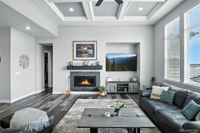 9538 Bear River St, Littleton, CO 80125 - living area with wood finished floors, a ceiling fan, coffered ceiling, a stone fireplace, and beamed ceiling