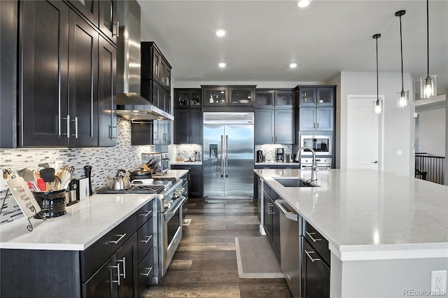 9538 Bear River St, Littleton, CO 80125 - kitchen with built in appliances, dark wood-style flooring, a spacious island, wall chimney exhaust hood, and decorative backsplash