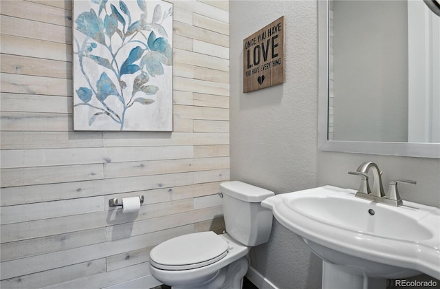 9538 Bear River St, Littleton, CO 80125 - half bath featuring a textured wall and wooden walls