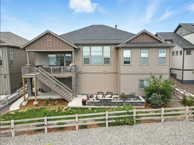 9538 Bear River St, Littleton, CO 80125 - rear view of house with board and batten siding, a fenced backyard, stairs, and a patio area