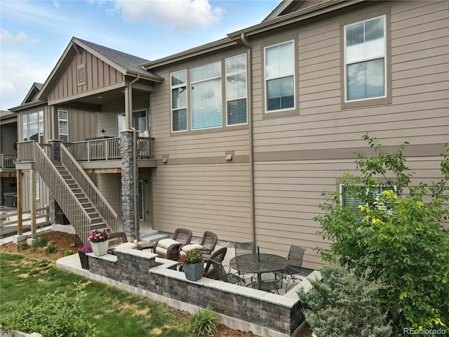 9538 Bear River St, Littleton, CO 80125 - view of side of home with stairs, board and batten siding, a wooden deck, and a patio area