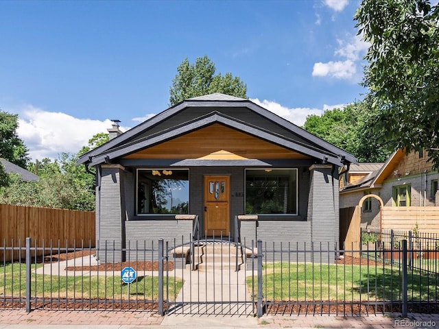 883 S Downing St, Denver, CO 80209 - shotgun-style home featuring brick siding, a fenced front yard, covered porch, and a chimney