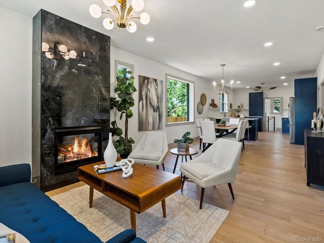 883 S Downing St, Denver, CO 80209 - living area featuring a chandelier, light wood-type flooring, recessed lighting, and a premium fireplace