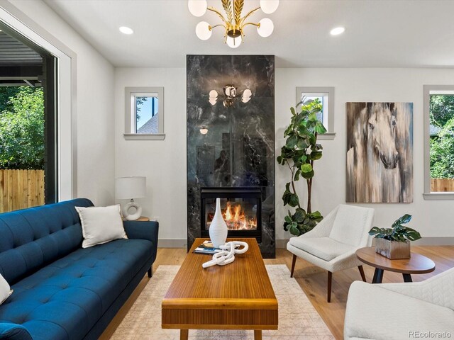 883 S Downing St, Denver, CO 80209 - living area with a chandelier, light wood-style flooring, a high end fireplace, and recessed lighting