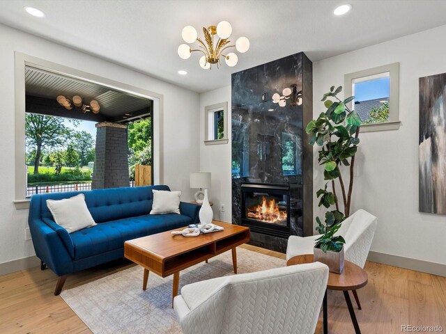 883 S Downing St, Denver, CO 80209 - living room featuring plenty of natural light, a premium fireplace, wood finished floors, a chandelier, and recessed lighting