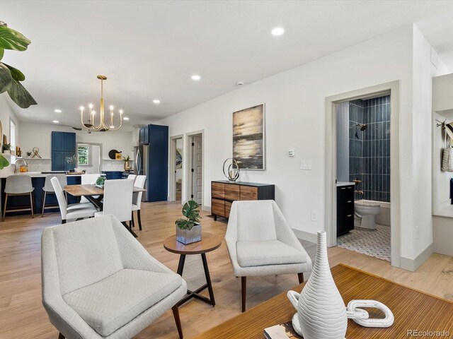883 S Downing St, Denver, CO 80209 - living area with a chandelier, recessed lighting, and light wood finished floors