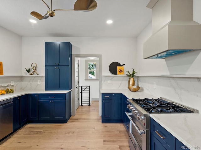 883 S Downing St, Denver, CO 80209 - kitchen with stainless steel range, open shelves, blue cabinetry, dishwasher, and custom range hood