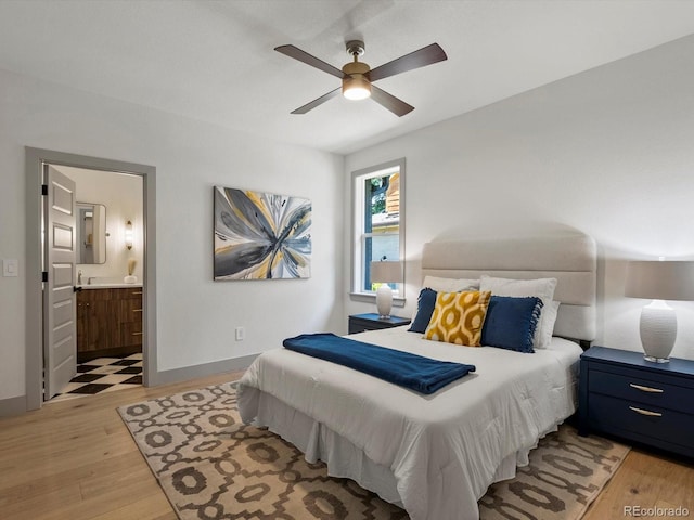 883 S Downing St, Denver, CO 80209 - bedroom with light wood-type flooring, ensuite bathroom, and a ceiling fan