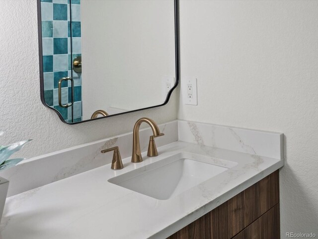 883 S Downing St, Denver, CO 80209 - bathroom with vanity and a textured wall