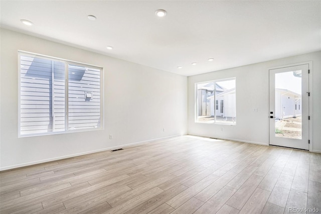 empty room with light hardwood / wood-style flooring