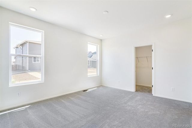 carpeted empty room featuring plenty of natural light