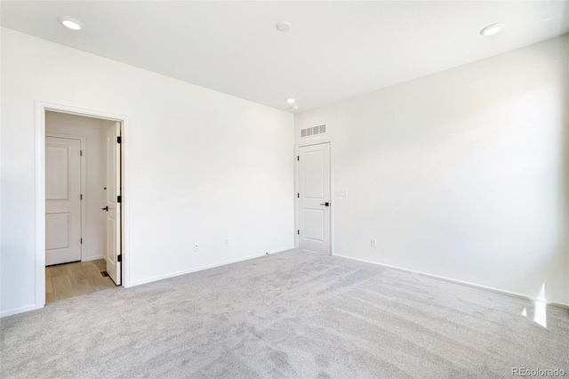 unfurnished room with light colored carpet