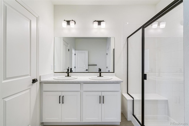 bathroom with vanity and a shower with shower door