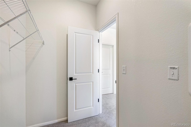 hallway with light colored carpet