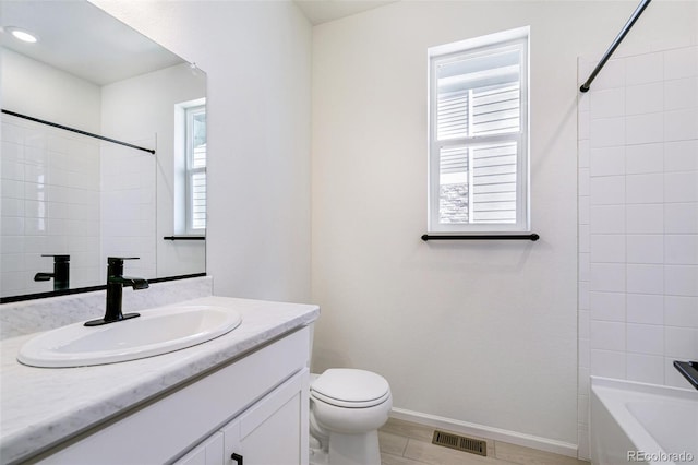 full bathroom with toilet, tiled shower / bath, and vanity