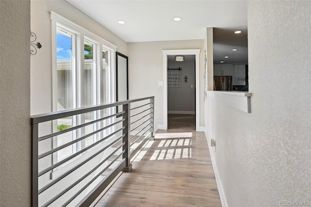 3340 Afternoon Cir, Colorado Springs, CO 80910 - corridor with wood finished floors, recessed lighting, and a textured wall