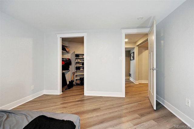 3340 Afternoon Cir, Colorado Springs, CO 80910 - bedroom with light wood-type flooring, a walk in closet, and a closet