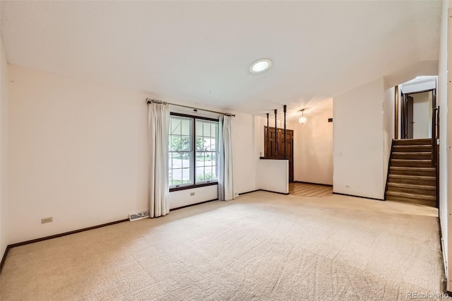 2556 S Eagle Cir, Aurora, CO 80014 - empty room with light colored carpet, baseboards, and stairs