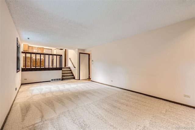 2556 S Eagle Cir, Aurora, CO 80014 - spare room with carpet flooring, stairway, a textured ceiling, and baseboards
