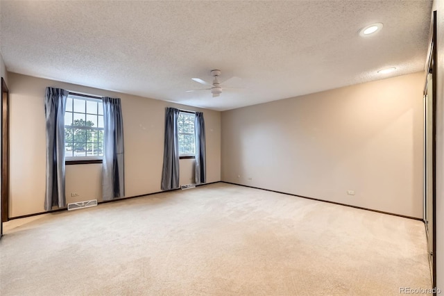 2556 S Eagle Cir, Aurora, CO 80014 - empty room with a textured ceiling, light colored carpet, a ceiling fan, baseboards, and recessed lighting