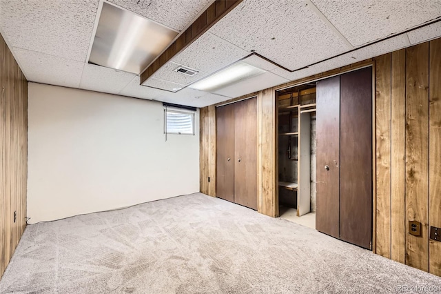 2556 S Eagle Cir, Aurora, CO 80014 - unfurnished bedroom with carpet, wooden walls, and two closets